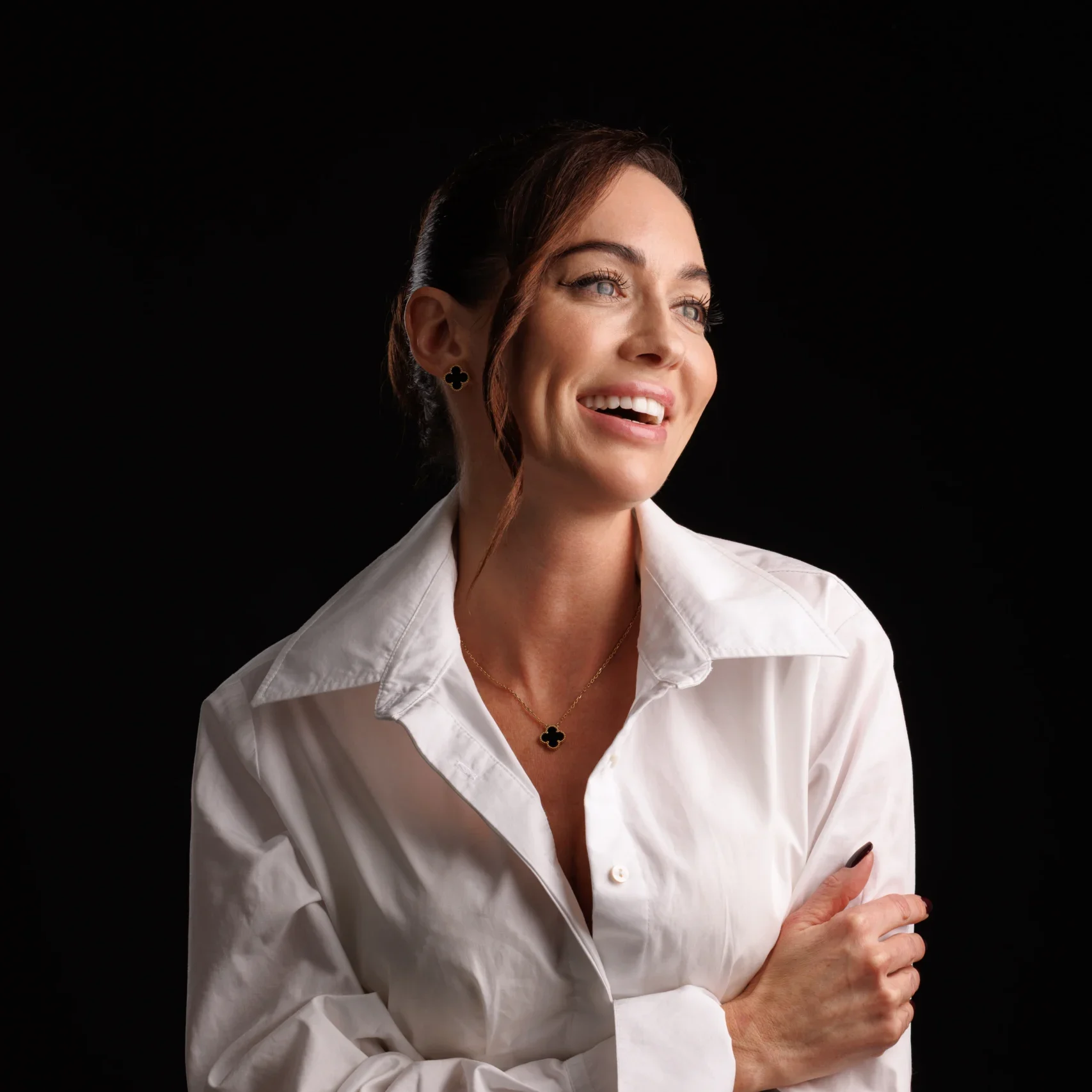 Portrait in a white shirt against a dark backdrop